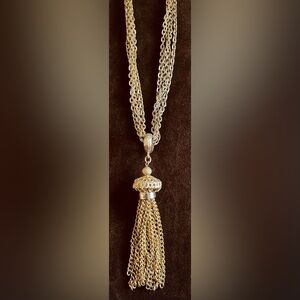 4 CHAIN TASSEL PENDANT. GOLD TONE WITH INTRICATE-DETAILED CLASP AND TASSEL BALL